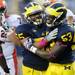 Michigan defensive tackle Jibreel Black and defensive end Mario Ojemudia celebrate a sack during the fourth quarter at Michigan Stadium on Saturday.  Melanie Maxwell I AnnArbor.com